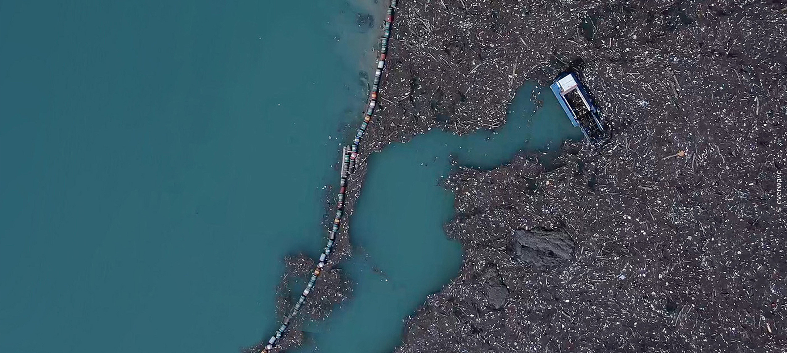 a river full with rubbish and a cleaning boat